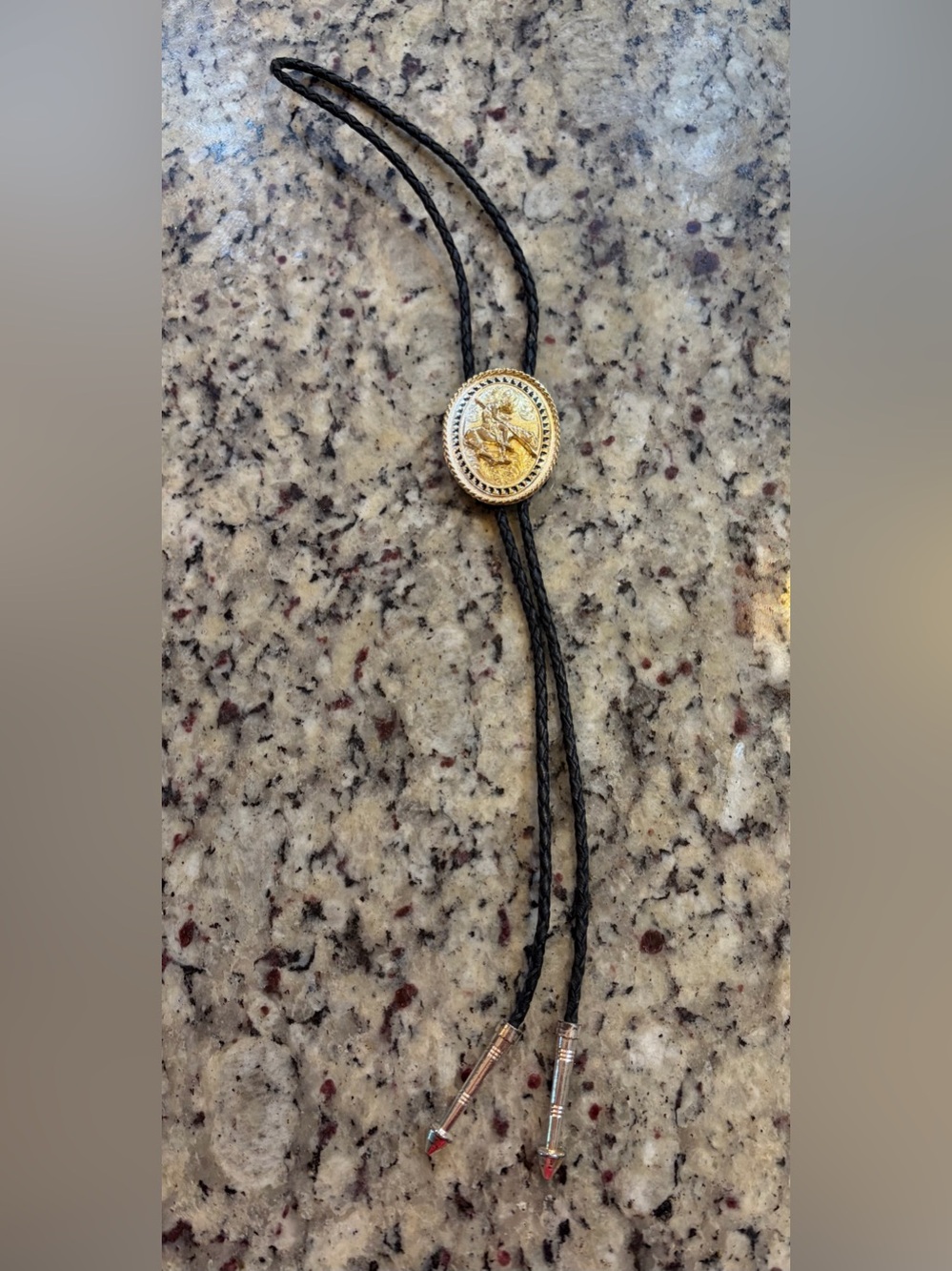 Montana Silversmiths Rodeo Cowboy Gold Medallion Bolo with Black Braided Cord